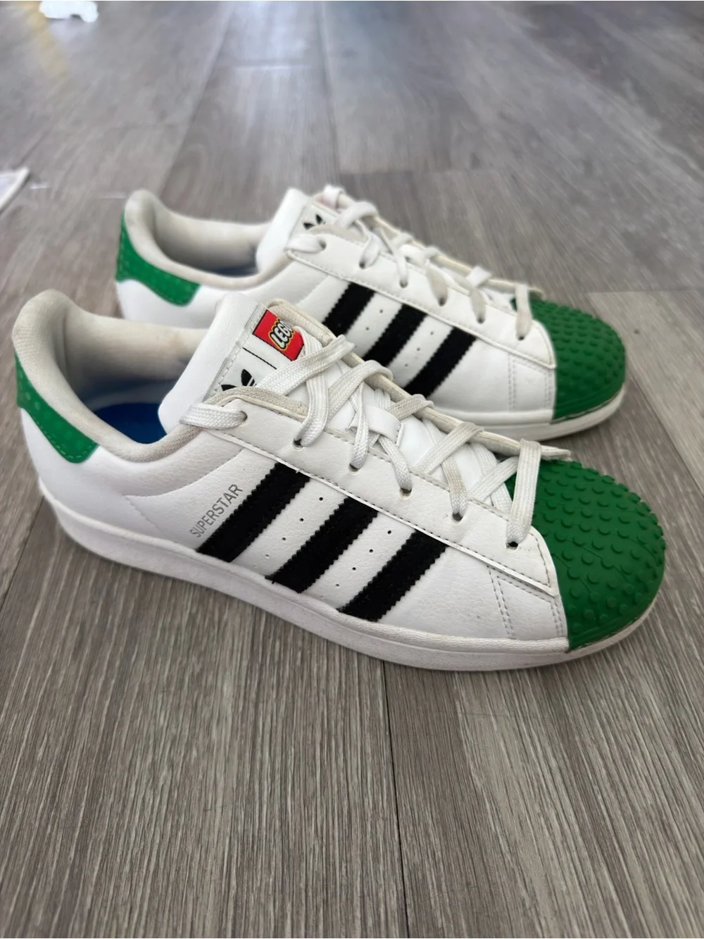 Adidas Men’s Lego’s Edition Superstar Sneakers in White, Black & Green